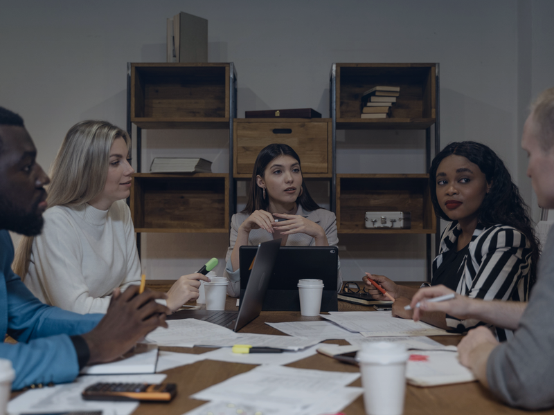 Diverse business consulting team collaborating in modern office